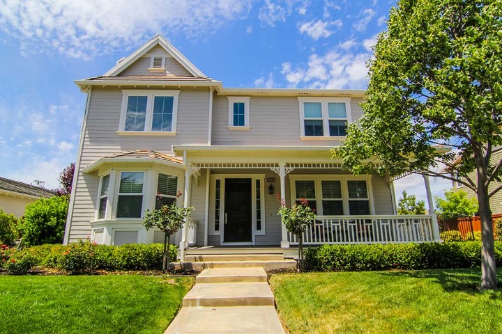 Two-story home with a covered front porch, listed on the MLS